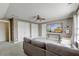 Attic living room featuring a flat screen tv, sofa, white double doors, and a ceiling fan at 122 Foxglove Ave, Summerville, SC 29483