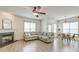 Open-concept living room with a fireplace, ceiling fan, and a sectional sofa with dining area in view at 122 Foxglove Ave, Summerville, SC 29483