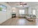 Spacious living room featuring a fireplace, ceiling fan, and a large sectional sofa at 122 Foxglove Ave, Summerville, SC 29483