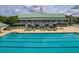 Expansive swimming pool with clear water, lined with lounge chairs, and a clubhouse beyond at 122 Foxglove Ave, Summerville, SC 29483