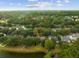 Beautiful aerial view of home surrounded by trees near a pond at 1232 Palmetto Peninsula Dr, Mount Pleasant, SC 29464