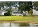 Charming backyard with screen porch overlooking the pond at 1232 Palmetto Peninsula Dr, Mount Pleasant, SC 29464