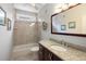 Bright bathroom with granite counter, cherry cabinets, tub, and window at 1232 Palmetto Peninsula Dr, Mount Pleasant, SC 29464