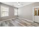 A bedroom featuring hardwood floors, ceiling fan, and windows for natural light at 1232 Palmetto Peninsula Dr, Mount Pleasant, SC 29464