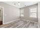A bedroom featuring hardwood floors, ceiling fan, and windows for natural light at 1232 Palmetto Peninsula Dr, Mount Pleasant, SC 29464