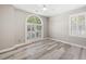 A bedroom featuring hardwood floors, ceiling fan, and windows for natural light at 1232 Palmetto Peninsula Dr, Mount Pleasant, SC 29464