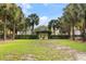 Lush community green space with palm trees and manicured hedges under a bright blue sky at 1232 Palmetto Peninsula Dr, Mount Pleasant, SC 29464