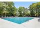 Inviting community pool with plenty of lounge chairs for relaxing in a beautiful green setting at 1232 Palmetto Peninsula Dr, Mount Pleasant, SC 29464
