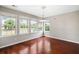 This is an empty living room with lots of natural light and hard wood floors at 1232 Palmetto Peninsula Dr, Mount Pleasant, SC 29464