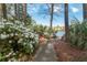 Path leading to bench overlooking a pond surrounded by trees and blooming azaleas at 1232 Palmetto Peninsula Dr, Mount Pleasant, SC 29464