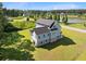 Aerial view of home with lush green lawn and community pond at 1327 Wood Sorrel Dr, Moncks Corner, SC 29461