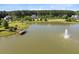 Scenic view of community pond with fountain and wooden dock at 1327 Wood Sorrel Dr, Moncks Corner, SC 29461