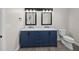Bathroom featuring a double vanity with white marble countertop and blue cabinets at 1327 Wood Sorrel Dr, Moncks Corner, SC 29461
