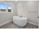 Contemporary bathroom with a sleek, standalone white bathtub and modern fixtures at 1327 Wood Sorrel Dr, Moncks Corner, SC 29461