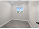 Bright bedroom featuring a window with natural light, wood-look floors, and neutral wall color at 1327 Wood Sorrel Dr, Moncks Corner, SC 29461