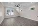 Spacious bedroom with grey floors, crown moulding, and natural light from multiple windows at 1327 Wood Sorrel Dr, Moncks Corner, SC 29461