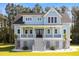 Charming two-story home with a inviting front porch and a well-manicured lawn and a beautiful garden at 1327 Wood Sorrel Dr, Moncks Corner, SC 29461