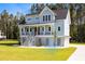 Charming two-story blue home with a welcoming porch, situated on a well-manicured lawn at 1327 Wood Sorrel Dr, Moncks Corner, SC 29461