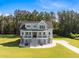 Stunning two-story blue home with a welcoming porch and manicured lawn at 1327 Wood Sorrel Dr, Moncks Corner, SC 29461