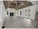 Spacious living room featuring vaulted ceilings, fireplace, modern lighting, and hardwood floors at 1327 Wood Sorrel Dr, Moncks Corner, SC 29461