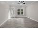 A well lit room with gray floors, a ceiling fan, and a window at 1327 Wood Sorrel Dr, Moncks Corner, SC 29461