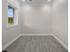 A simple room with gray flooring and a window at 1327 Wood Sorrel Dr, Moncks Corner, SC 29461