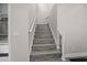 A gray staircase with white railings and a window at the top at 1327 Wood Sorrel Dr, Moncks Corner, SC 29461