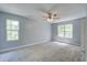 Spacious bedroom with neutral carpeting, ceiling fan, and great natural light from two windows at 137 Ashton Dr, Goose Creek, SC 29445