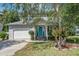 Charming two-story home with a light gray exterior, a blue front door, and well-maintained landscaping at 137 Ashton Dr, Goose Creek, SC 29445