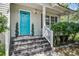 Inviting front entrance with a blue door, decorative plants, and a covered porch with elegant detailing at 137 Ashton Dr, Goose Creek, SC 29445