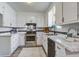Bright kitchen with white cabinets, black hardware, and stainless steel range at 137 Ashton Dr, Goose Creek, SC 29445