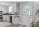 Efficient kitchen with white cabinets, black appliances, and a back door at 137 Ashton Dr, Goose Creek, SC 29445