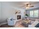 Bright living room featuring a fireplace, ceiling fan, and stylish decor with hardwood floors at 137 Ashton Dr, Goose Creek, SC 29445