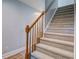 Carpeted staircase with a wooden handrail and decorative balusters at 137 Ashton Dr, Goose Creek, SC 29445