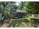 Landscaped backyard with mature trees and a screened patio attached to the home at 1414 E Crossing Ln, Mount Pleasant, SC 29466