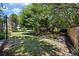 Spacious backyard with mature trees and a partial wood fence, providing a serene outdoor space at 1414 E Crossing Ln, Mount Pleasant, SC 29466