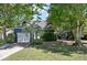 Charming home featuring mature trees, a well-manicured lawn, and a garage with a palm tree in the front yard at 1414 E Crossing Ln, Mount Pleasant, SC 29466
