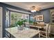Kitchen island with granite countertop next to table seating and large windows with backyard views at 1414 E Crossing Ln, Mount Pleasant, SC 29466