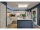 Bright kitchen features white cabinets, stainless appliances, and a center island with granite countertop, ideal for cooking at 1414 E Crossing Ln, Mount Pleasant, SC 29466