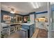 Open kitchen featuring white cabinets, a central island with seating, a dining area, and stainless steel appliances at 1414 E Crossing Ln, Mount Pleasant, SC 29466