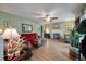Cozy living room with a fireplace, plush red sofa, comfortable armchairs, and natural light at 1414 E Crossing Ln, Mount Pleasant, SC 29466