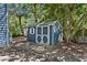Backyard shed painted blue with white trim; perfect for extra storage at 1414 E Crossing Ln, Mount Pleasant, SC 29466