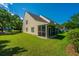 Exterior shot of home's backyard showing lawn, greenery, and screened porch at 149 Darcy Ave, Goose Creek, SC 29445