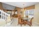 Dining area with glass table, wicker chairs, adjacent staircase with chair lift, and a view into the living room at 149 Darcy Ave, Goose Creek, SC 29445
