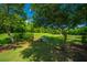 Lush green space featuring mature trees, manicured lawn, and a charming fountain in the background at 149 Darcy Ave, Goose Creek, SC 29445