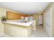 Open kitchen featuring wood cabinets, white appliances, and a breakfast bar overlooking the adjacent living area at 149 Darcy Ave, Goose Creek, SC 29445