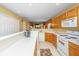 Kitchen with white countertops, wood cabinets, and white appliances, opening to the living and dining area at 149 Darcy Ave, Goose Creek, SC 29445