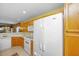 Kitchen with white countertops, wood cabinets, and white appliances, opening to the living and dining area at 149 Darcy Ave, Goose Creek, SC 29445