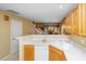 Bright kitchen features a white double sink, dishwasher, and light wood cabinets overlooking the living space at 149 Darcy Ave, Goose Creek, SC 29445