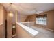 Loft area with neutral carpet, window and ceiling fan, and view of stairs at 149 Darcy Ave, Goose Creek, SC 29445
